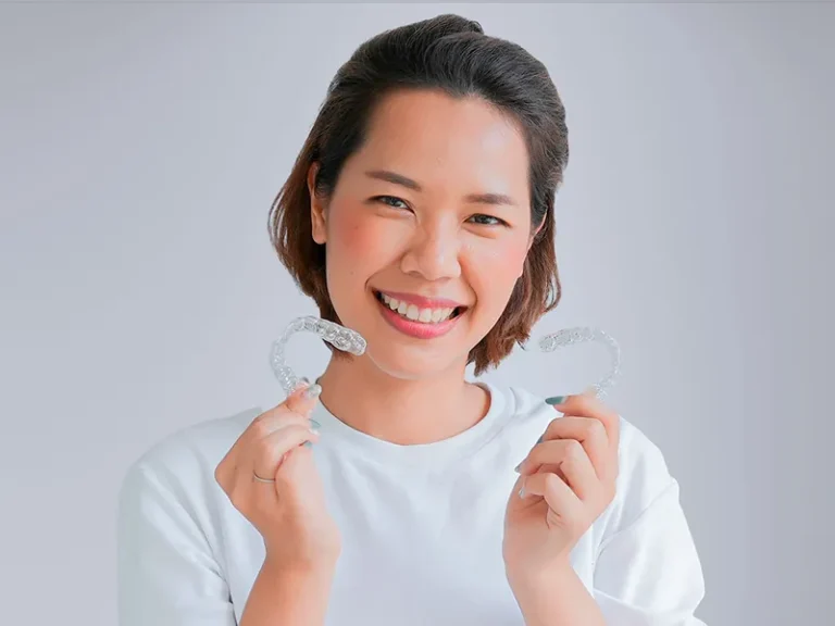 Invisalign 7 Smiling woman showing clear aligners as part of Bellingham dental care.