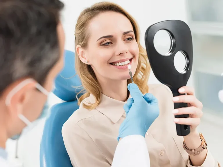 Veneers 4 Woman checking tooth shade during consultation at cosmetic dentist in Bellingham.