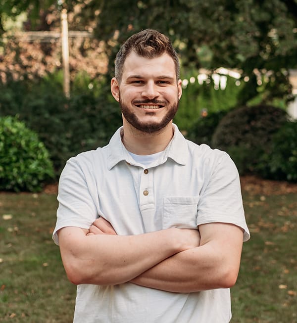 Meet the Doctor 9 Male team member at Roots Dental in Bellingham smiling outdoors, dedicated to patient care.