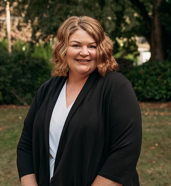 Meet the Doctor 15 Female team member at Roots Dental in Bellingham smiling outdoors, dedicated to patient comfort.