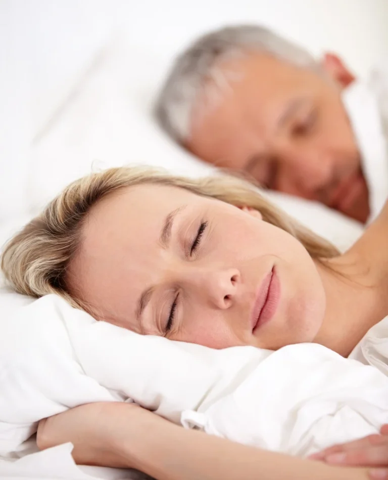 couple sleeping peacefully in bed together