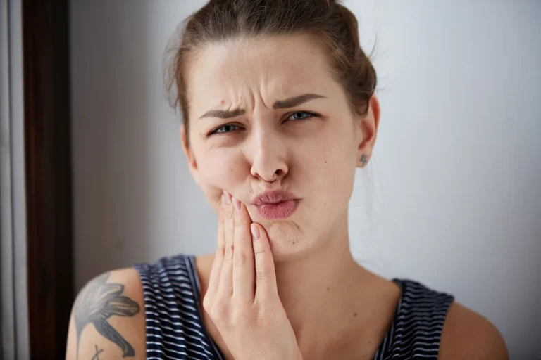 Young woman expressing discomfort or pain | emergency dentist Bellingham WA